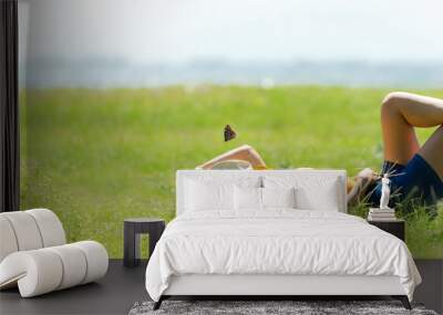 Woman relax and sleep chill  in the meadow  outdoor near sea beach.  Lifestyle and Vacations Concept Wall mural