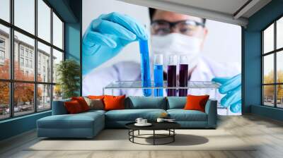 Biochemistry laboratory research, Chemist is analyzing sample in laboratory with equipment and science experiments glassware containing chemical liquid Wall mural