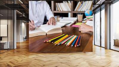 High school or college student group sitting at desk in library studying and reading, doing homework and lesson practice preparing exam to entrance, education concept Wall mural