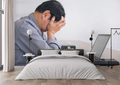 Image of Frustrated stressed business man and graph business with computer laptop in the workplace Wall mural