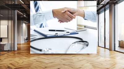 Professional Male doctor in white coat shaking hand with female patient after successful recommend treatment methods, Medicine and health care concept Wall mural