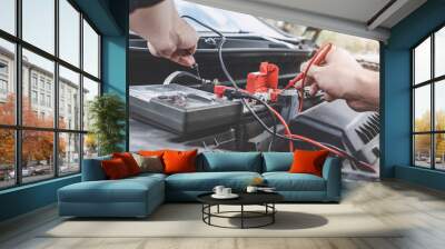 Services car engine machine concept, Automobile mechanic repairman hands checking a car engine automotive workshop with digital multimeter testing battery, car service and maintenance Wall mural