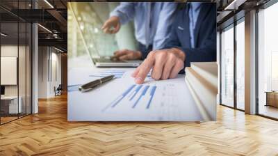 Teamwork process, Businessmen hands pointing at laptop and document during explanation of new plan project data at meeting. Wall mural