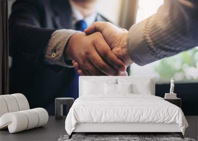 Two business men shaking hands during a meeting to sign agreement and become a business partner, enterprises, companies, confident, success dealing, contract between their firms Wall mural