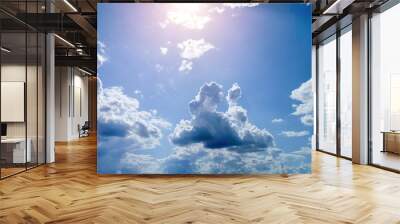 Cumulus clouds against a bright blue sky on a Sunny day. Wall mural