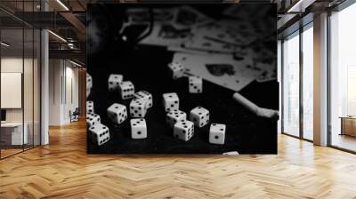 Dice,cigarettes, cards, and an abandoned alarm clock on a table in an underground casino.In black and white. Wall mural