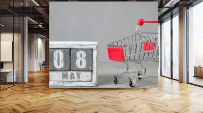 May 08, shopping cart and wooden calendar gray background.Concept for Fair Trade Day. Wall mural