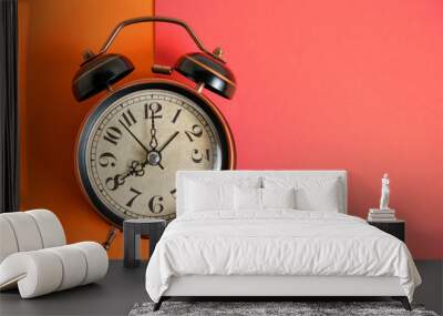 Old, vintage retro alarm clock on orange red background. Wall mural