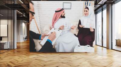 Arab man speaks with his wife at office. Wall mural