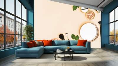 Circular mirror; compact powder; lipstick and makeup brushes with leaves on pastel background Wall mural