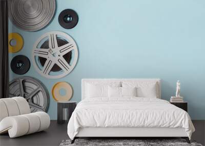 Different type of film reels cases on blue background Wall mural