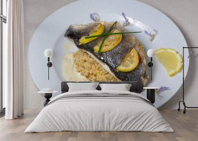 Lemon spiked sea bream fillet, cooked wheat risotto on plate Wall mural