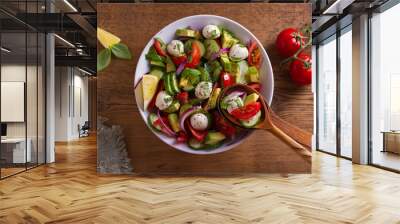 Avocado, tomato, cucumber salad with mozzarella cheese. View from above, top studio shot Wall mural