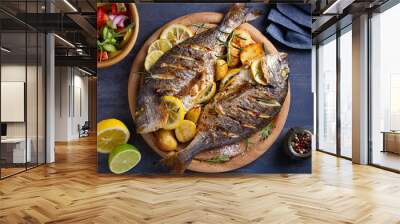 Roasted fish and potatoes, served on wooden tray. overhead, horizontal - image Wall mural