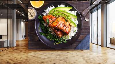 Salmon teriyaki rice bowl with spinach and avocado. View from above, top studio shot Wall mural