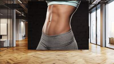 fitness female woman with muscular body, do her workout, abs, abdominals Wall mural