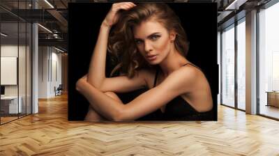 Vogue style close-up portrait of beautiful woman with long curly blond hair on black background Wall mural