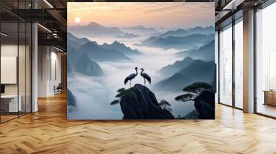 A serene landscape featuring two cranes standing on a rocky outcrop, gazing at each other. Wall mural