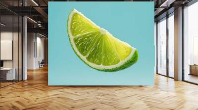 Fruit slice of lime suspended in the air on blue background Wall mural