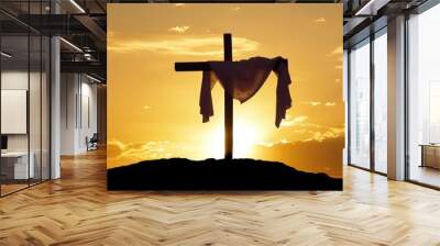 A cross on top of a hill with the sun setting behind it. White cloth hung on Cross crucifix, Easter background Wall mural