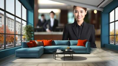 Female Asian hotel manager welcomes quests in lobby of a business hotel. Generative AI. Wall mural