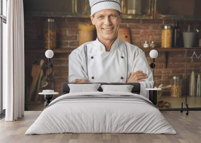  Mature man professional chef cooking meal indoors Wall mural