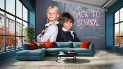 Close-up of little school boy and girl near blackboard Wall mural