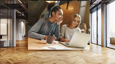 Collaboration. Businesswomen have a meeting in a modern cafe Wall mural