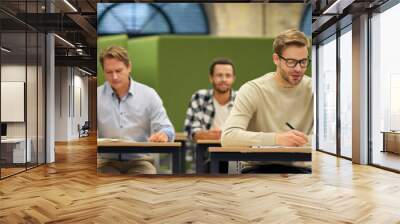 Corporate training. Group of multiracial people sitting in the modern office and listening to coach or speaker during business seminar Wall mural