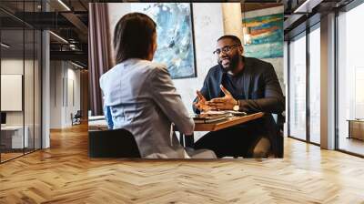 Dreams don't work unless you do. Two colleagues having lunch in company's restaurant. Focus on the man Wall mural