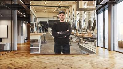 Good Wood Expert. Image of mature carpenter in the workshop Wall mural