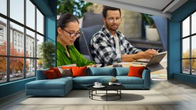 Group of young multiracial business people sitting at desk in the board room and working on project together, discussing work and sharing ideas Wall mural