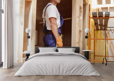 Handsome man builder standing in construction cabin Wall mural