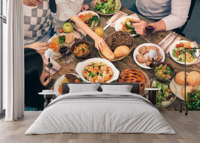 Nice family having tasty dinner Wall mural