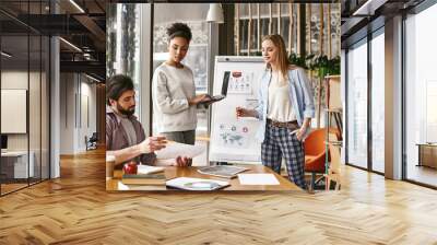 No one can whistle a symphony. It takes a whole orchestra to play it. Three co-workers are comparing results and developing a strategy Wall mural