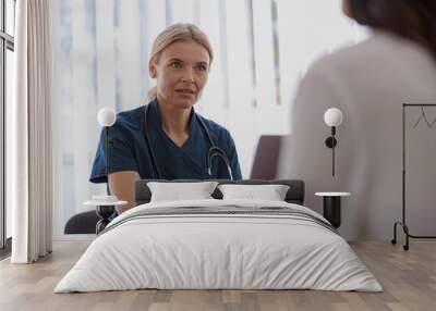 Therapist conducts a preventive examination of a woman in her office in a modern clinic Wall mural