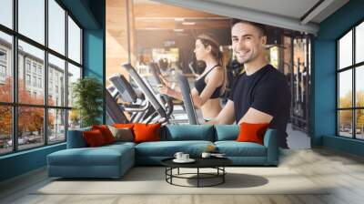 Young couple exercise together in gym healthy lifestyle Wall mural