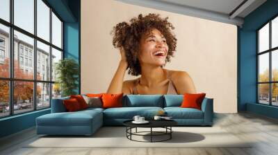 Young positive woman feeling relaxed in studio Wall mural