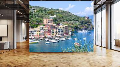 Beautiful aerial daylight view from top to ships on water and buildings in Portofino city of Italy. Tourists walking on sidewalk. Top view Wall mural