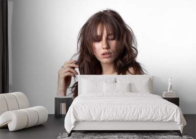 Close-up shot of a young caucasian girl with curly hair and bangs Wall mural