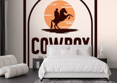 Vintage label with Silhouette of Cowboy on bucking horse at night Logo design inspiration Wall mural