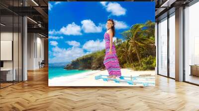 Young beautiful Asian  girl in blue dress on the beach of a trop Wall mural