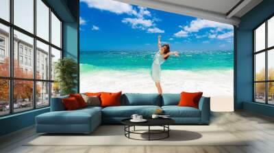 Young beautiful Asian  girl in blue dress on the beach of a trop Wall mural