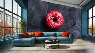 Pink donut with sprinkles, sweet glazed dessert food on dark concrete textured background, top view Wall mural