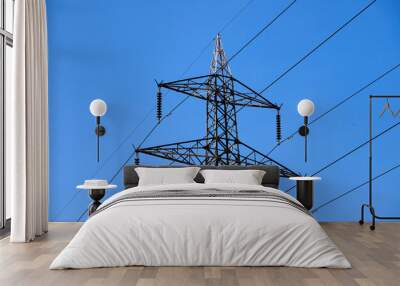 A power line tower with a blue sky in the background Wall mural