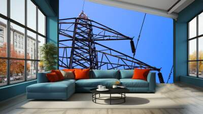 A power line tower with a blue sky in the background Wall mural