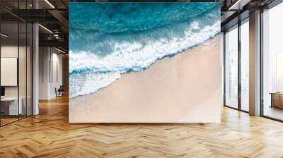 Beautiful aerial shot of a beach with nice sand, blue turquoise water. Top shot of a beach scene with a drone Wall mural