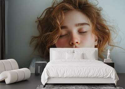 Young woman with curly hair relaxing indoors during daylight Wall mural