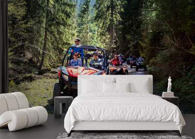 A tour group travels on ATVs and UTVs on the mountains Wall mural