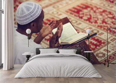 African Muslim Man Making Traditional Prayer To God While Wearing Dishdasha Wall mural